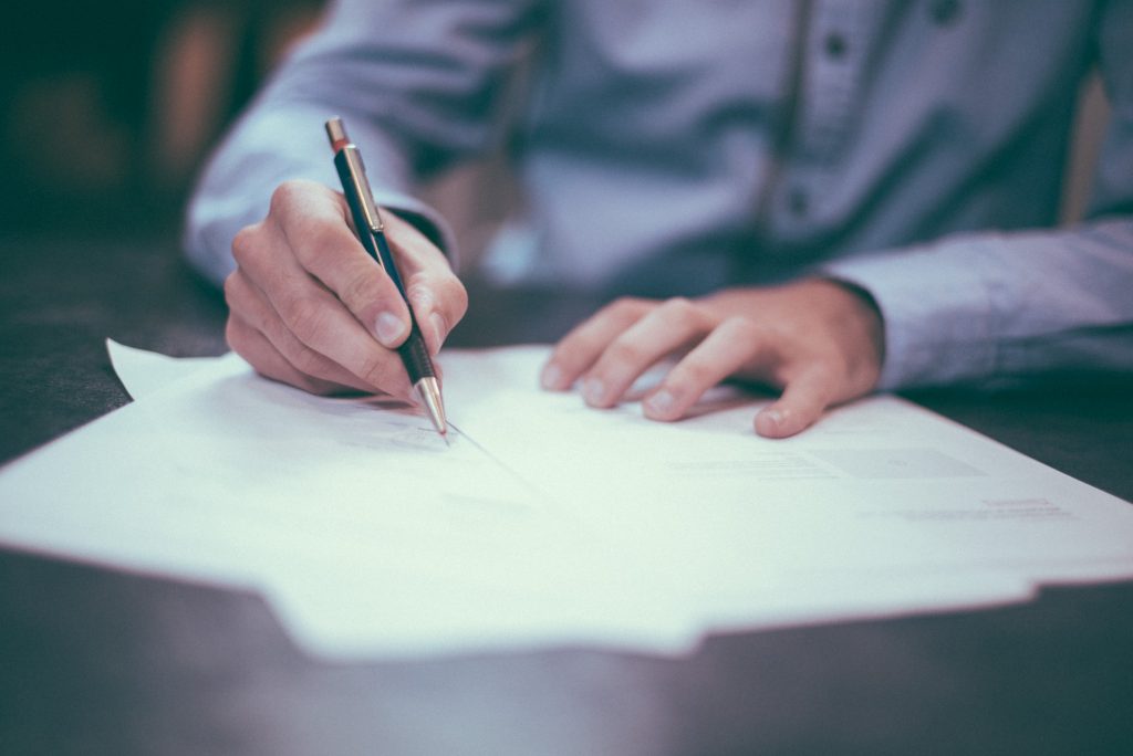 Guy signing papers